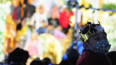 Un niño espera en una fila para tomarse fotos con los Reyes Magos