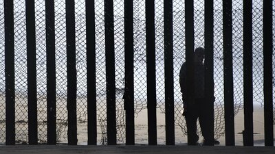 Un hombre en el lado mexicano de la frontera en Tijuana, Baja California